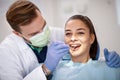Dentist checking up femaleÃ¢â¬â¢s teeth